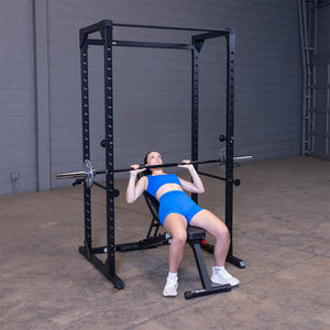 Man doing an incline barbell bench press inside the black Best Fitness BFPR100B power rack