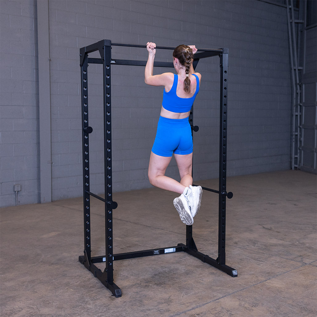 Woman doing a barbell split squat inside the black Best Fitness BFPR100B power rack