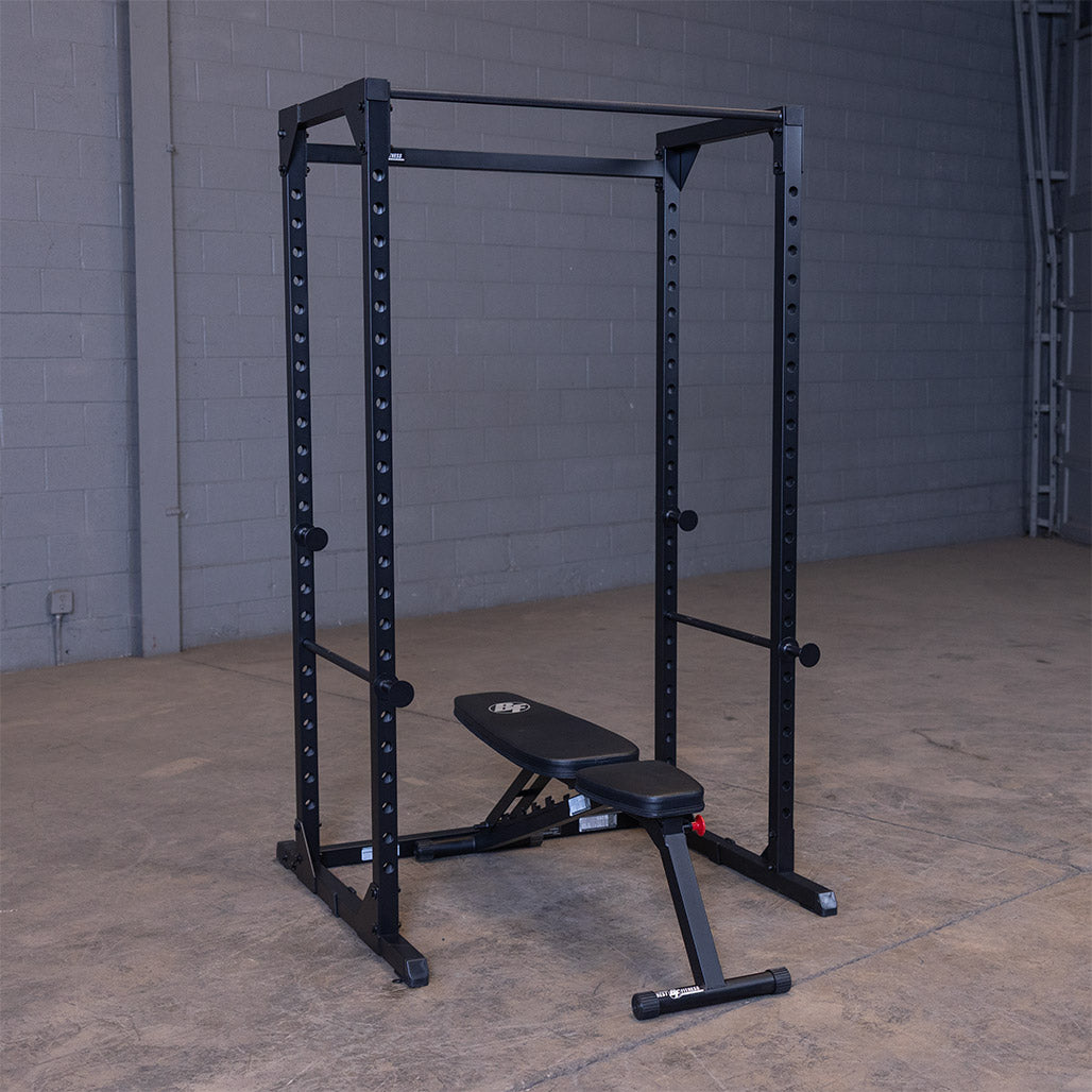 Black Best Fitness BFPR100B power rack with an adjustable bench set inside