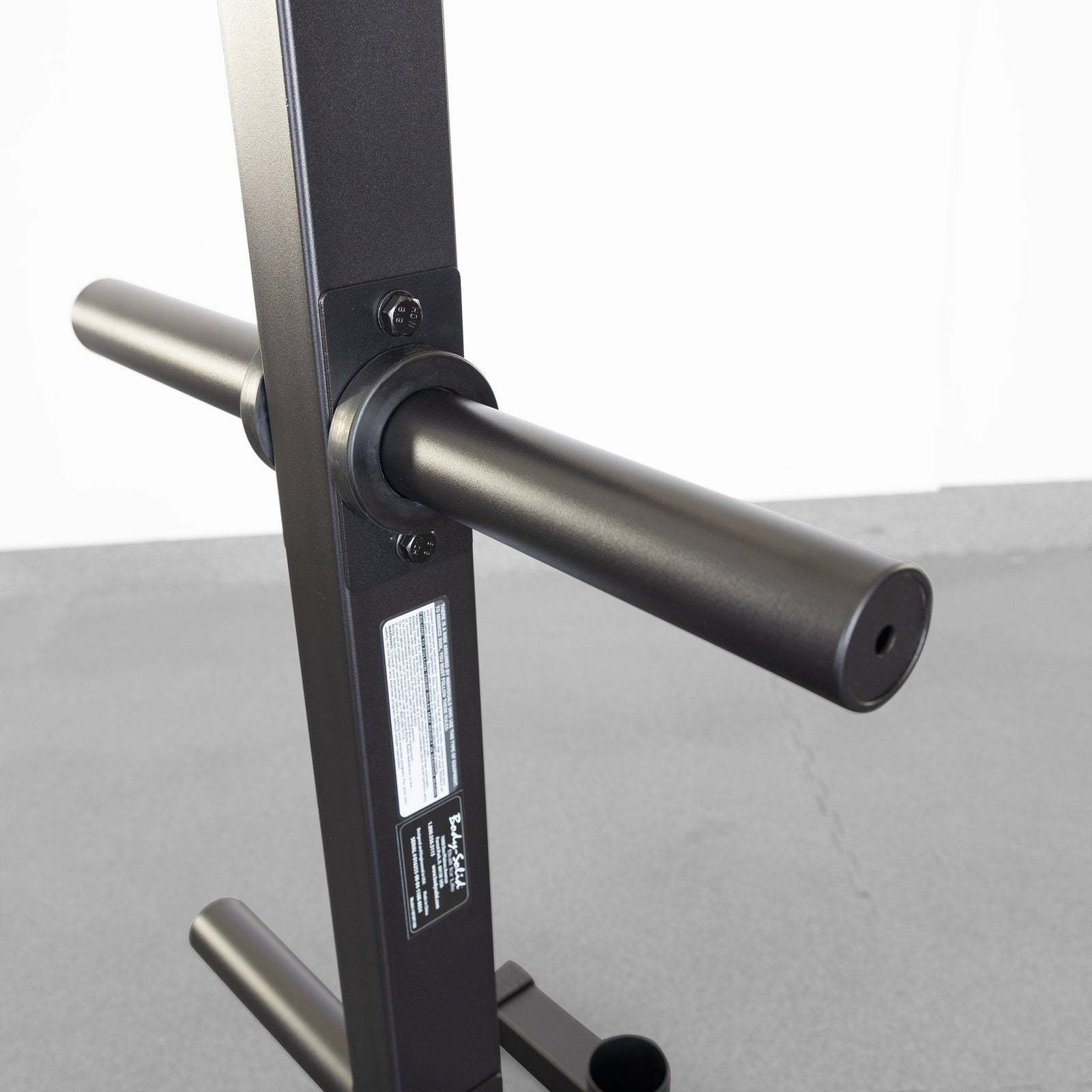 Best Fitness BFWT10B Olympic weight plate tree — loaded with coloured bumper plates and an Olympic bar