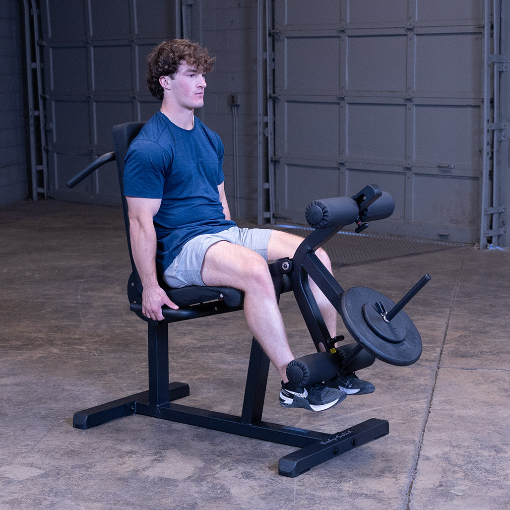 Body-Solid GLCE365B leg extension &amp; curl machine in use – seated leg extension, plate loaded