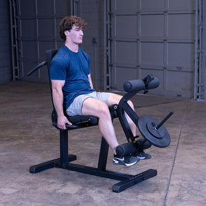 Body-Solid GLCE365B leg extension & curl machine in use – seated leg extension, plate loaded