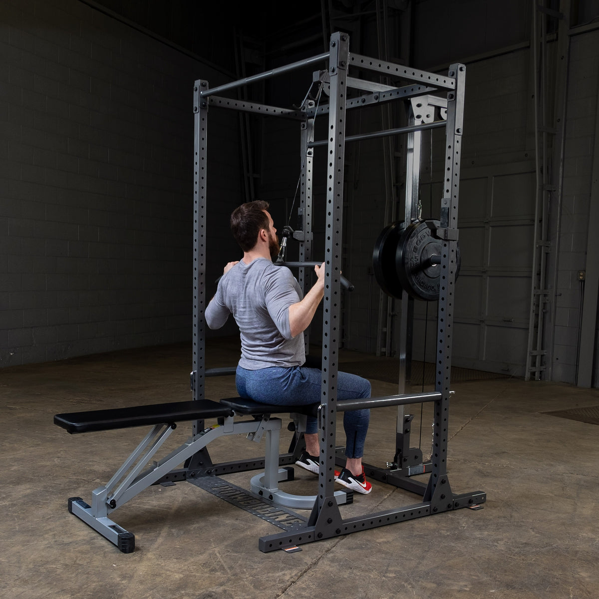 Man doing a seated lat pulldown with the Powerline PLA1000 Lat Attachment on the PPR1000X Power Rack