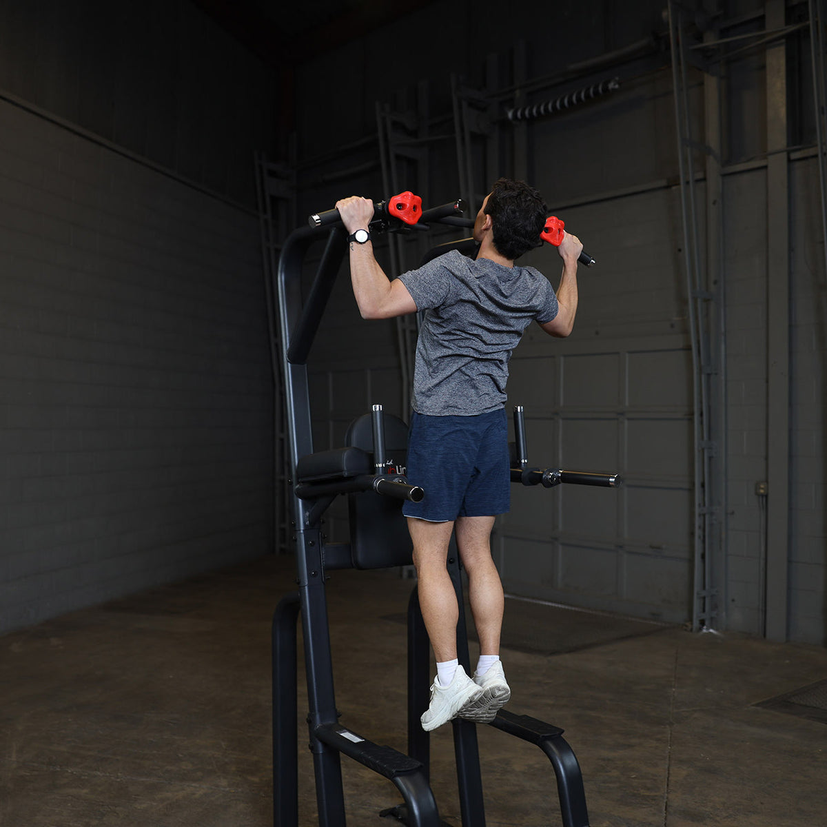 Body-Solid SVKR1000B Pro ClubLine Vertical Knee Raise — pull-up on the rock-climbing grips
